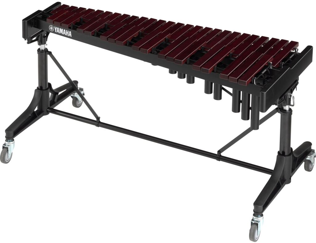 A xylophone on a stand with wheels.