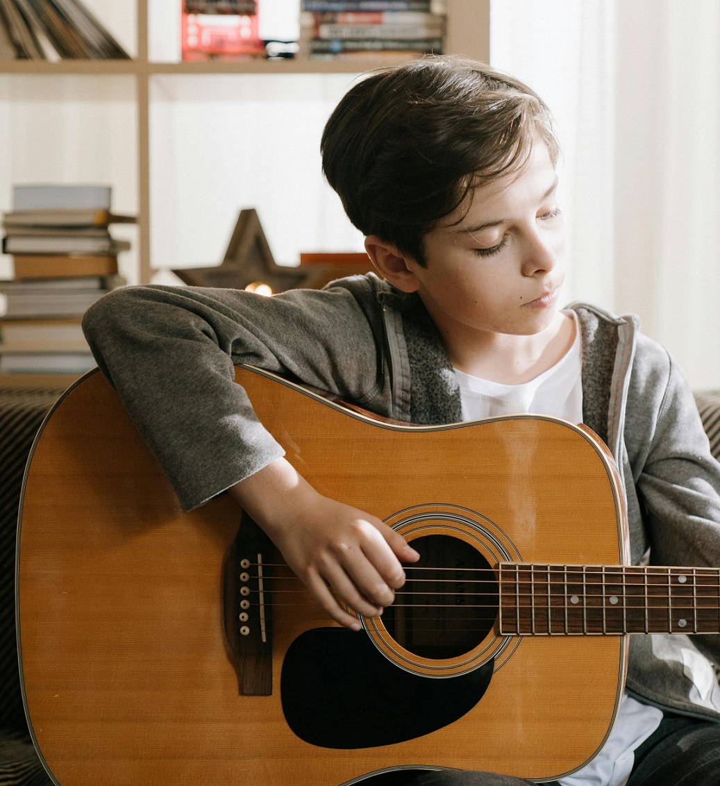 male student playing guitar