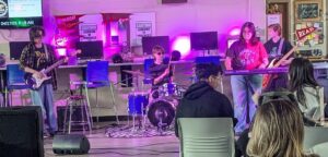 four modern band students performing