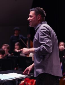 music educator in front of ensemble during rehearsal