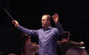 male music educator conducting rehearsal
