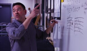 music educator at whiteboard