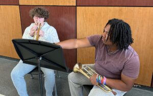 two trumpet students rehearsing