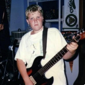 young boy playing electric guitar