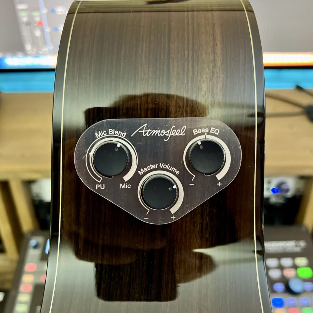 A closeup of the Atmosfeel pickup controls on a Yamaha FS9 RX acoustic guitar.