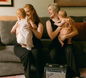 Alexandra Blaine and Annie Ray holding their daughters