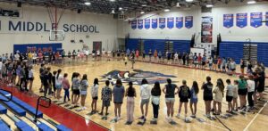 IMPACT! Middle School Summer Band Camp students standing in circle