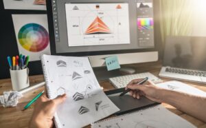 designing logo on paper and computer