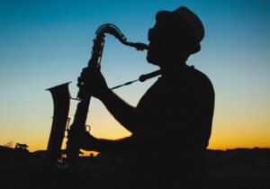 silhouette of man playing saxophone