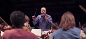 male music educator conducting rehearsal