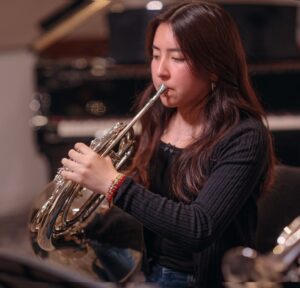 student playing French horn