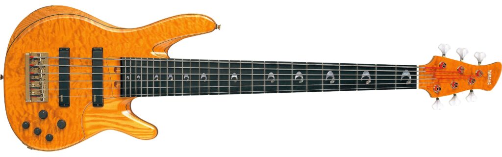 A natural wood six-string Yamaha electric bass.