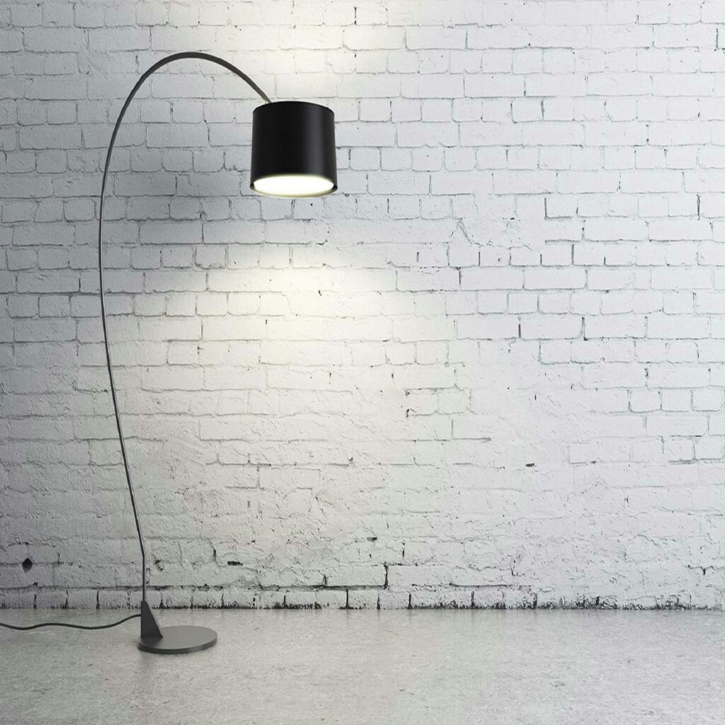 A floor lamp in a room with a white brick wall.