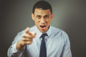 angry man with scowl and pointing with his index finger