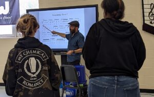 Jacob Abbott teaching students on bucket drumming
