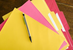 colorful folders with pen on top