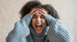 angry parent with hands on her face