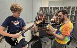 Adam Odenwelder with a guitar student