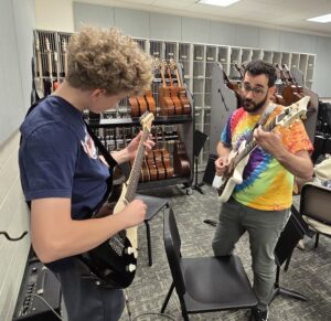 Adam Odenwelder with a guitar student