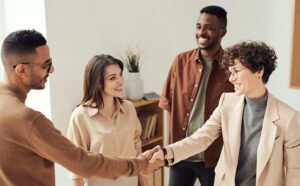 happy parents shaking teacher's hand