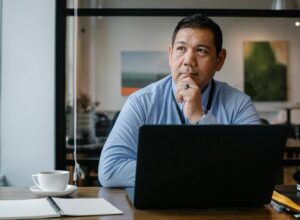 principal or head of school sitting in front of laptop