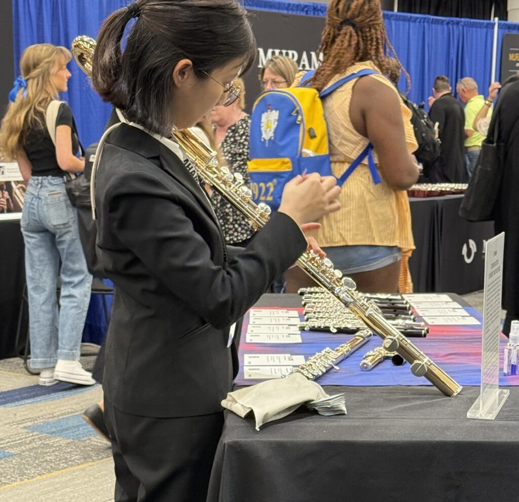 person looking at flute at at the National Flute Association