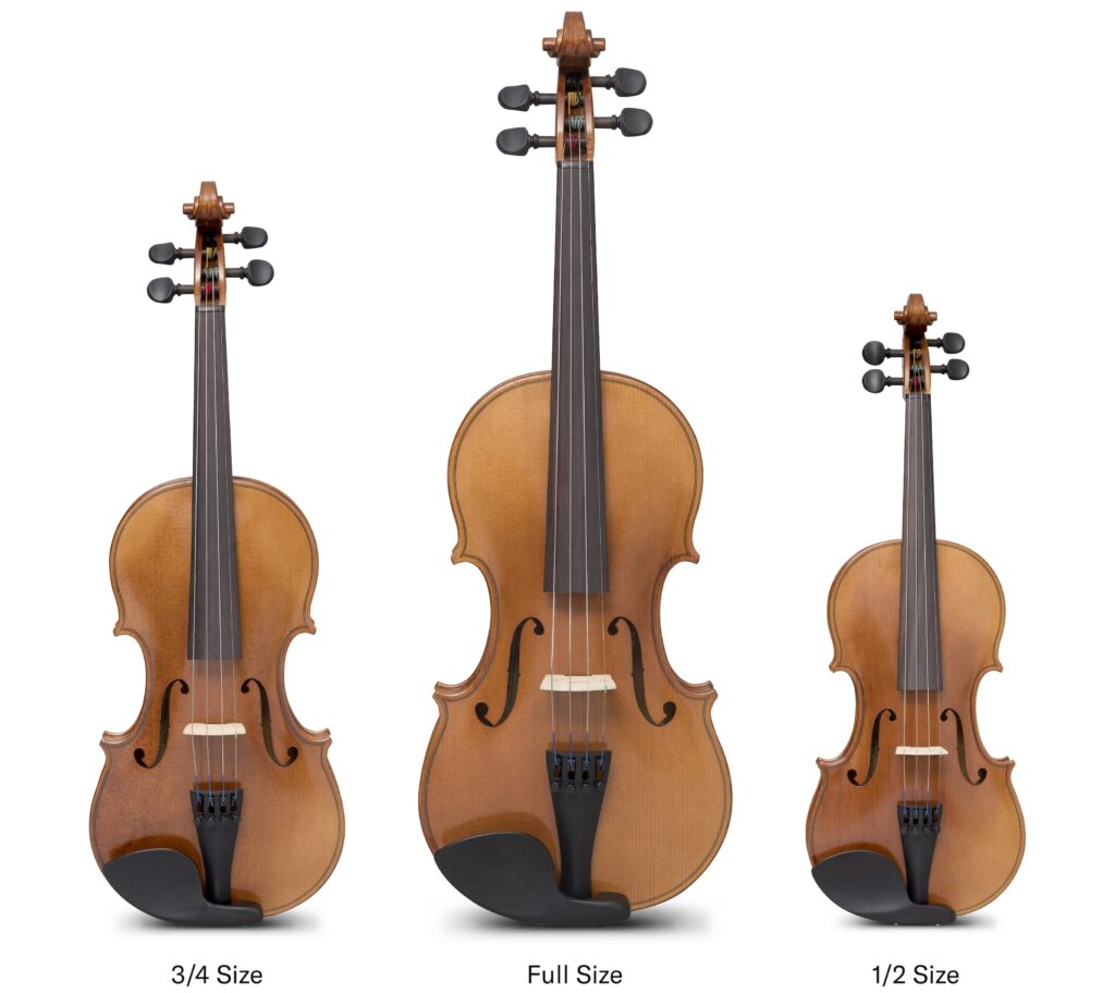 Three student violins. The one on the left is three-quarter size, the one in the center is full-size and the one on the right is half-size.
