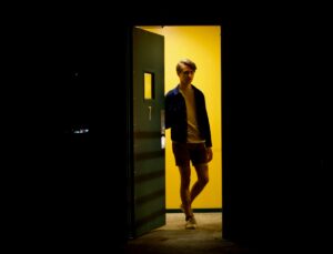 young man opening door