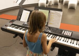 child exploring the keyboard during Meet the Opera workshop