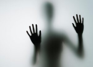 indistinguishable person behind frosted glass 