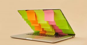 laptop with sticky notes covering the screen