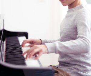 torso of a student playing piano