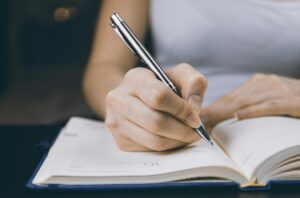 someone writing in a planner