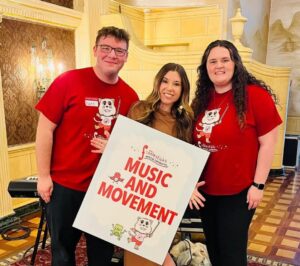 Dr. Cassandra Eisenreich and two of her students holding up Fiddlesticks course sign 