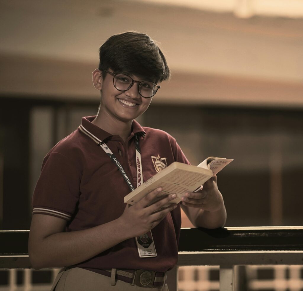happy student holding open book