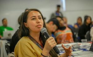 woman asking question at conference