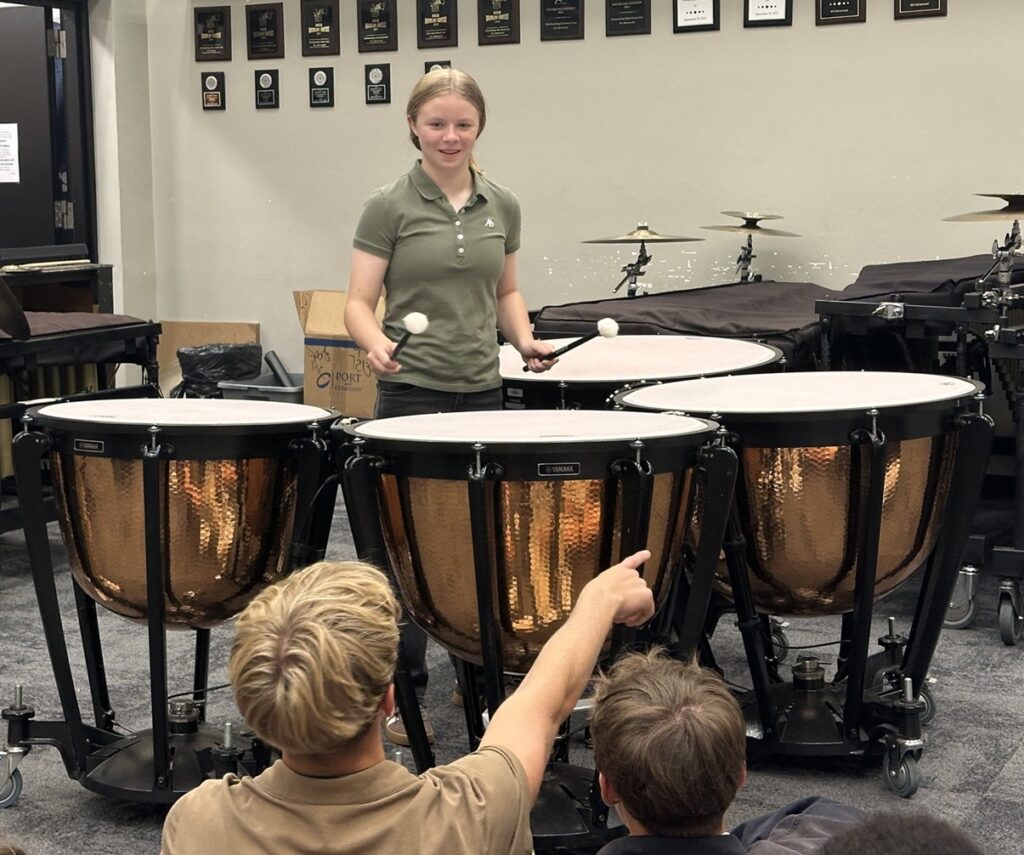 female student playing timpani