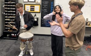 male student playing snare drum