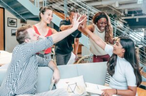 group high five among coworkers