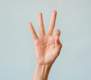 hand with three fingers held up