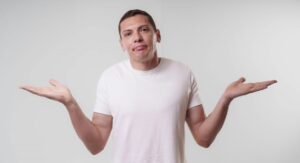 man shrugging and holding hands up