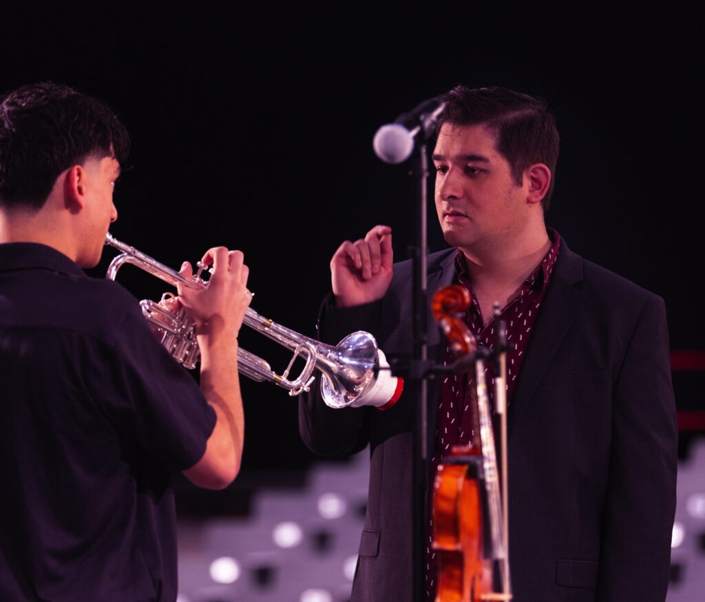 music teacher talking to trumpet player