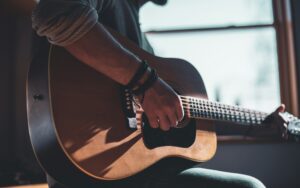 closeup of student playing guitar