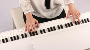 closeup of student playing the piano