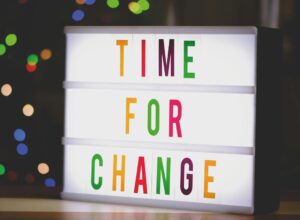 colorful sign that reads "Time for Change"