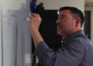 music teacher writing on white board