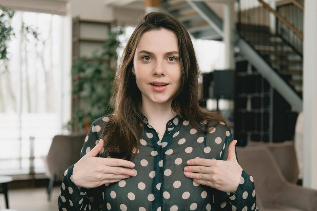 woman pointing to herself with her hands