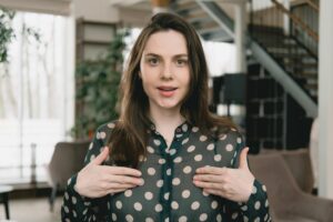 woman pointing to herself with her hands