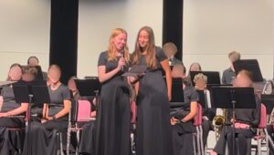 two female students speaking during ensemble concert