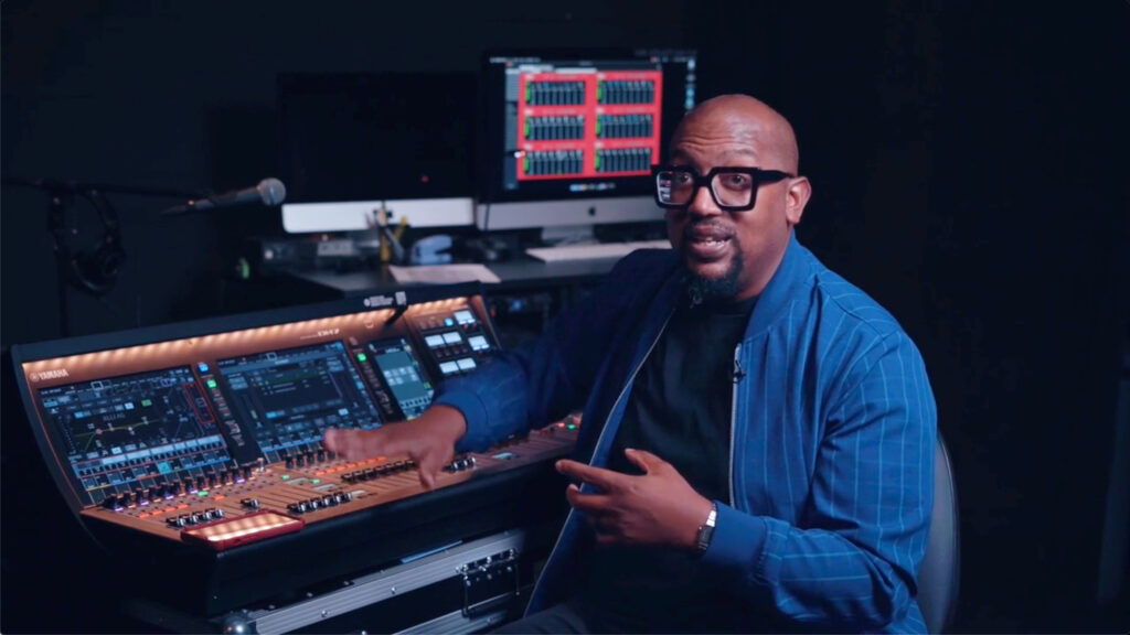 man next to audio mixer